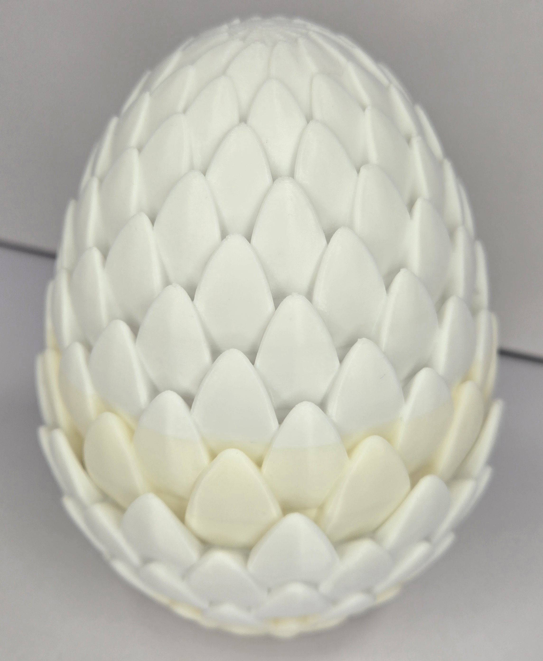 White dragon egg, scale-textured and closed